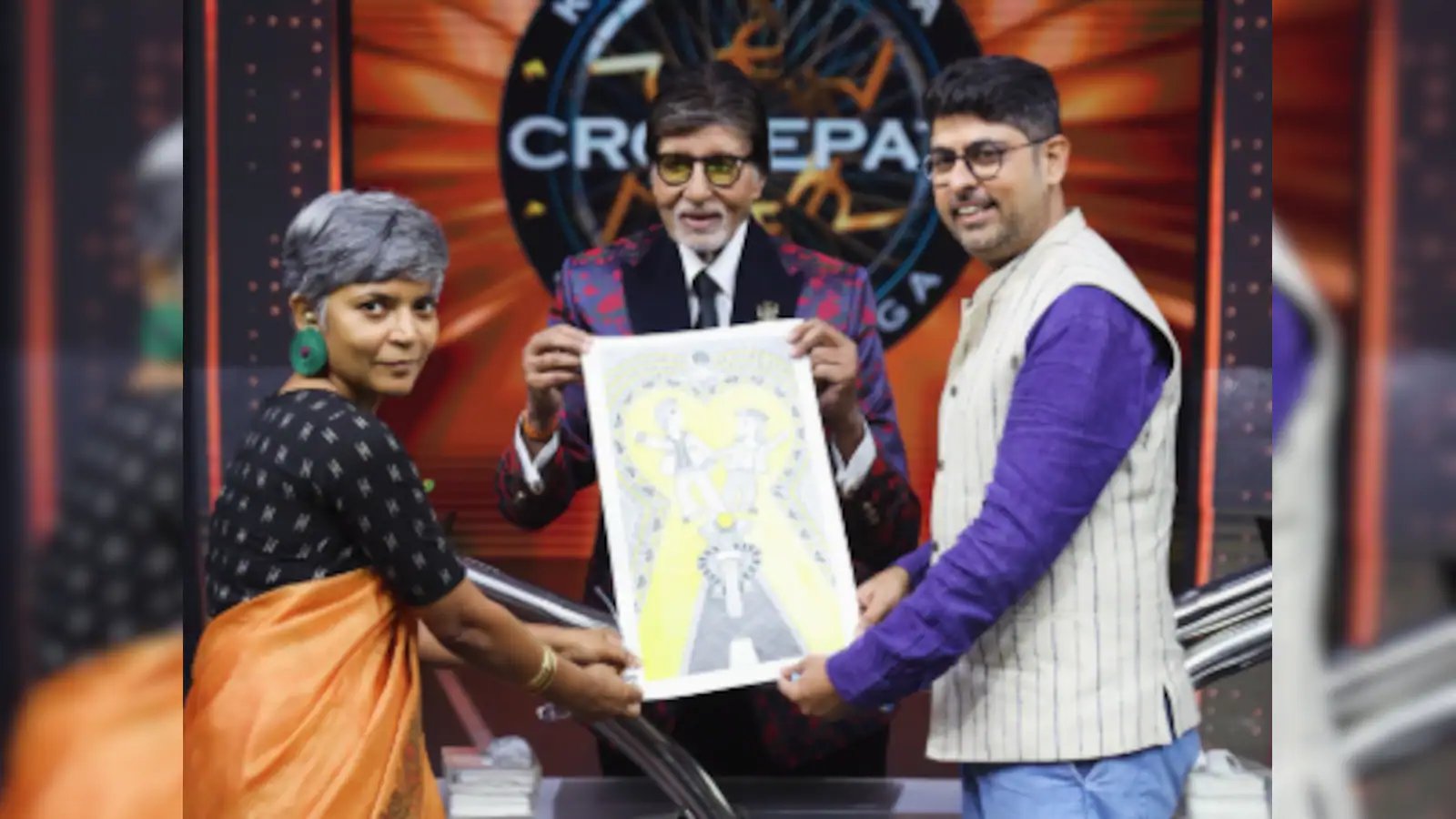 Amitabh Bachchan receives a poster of Madhubani made by a fan Sholay on the Who will become a millionaire? set up Image courtesy, Varun Grover